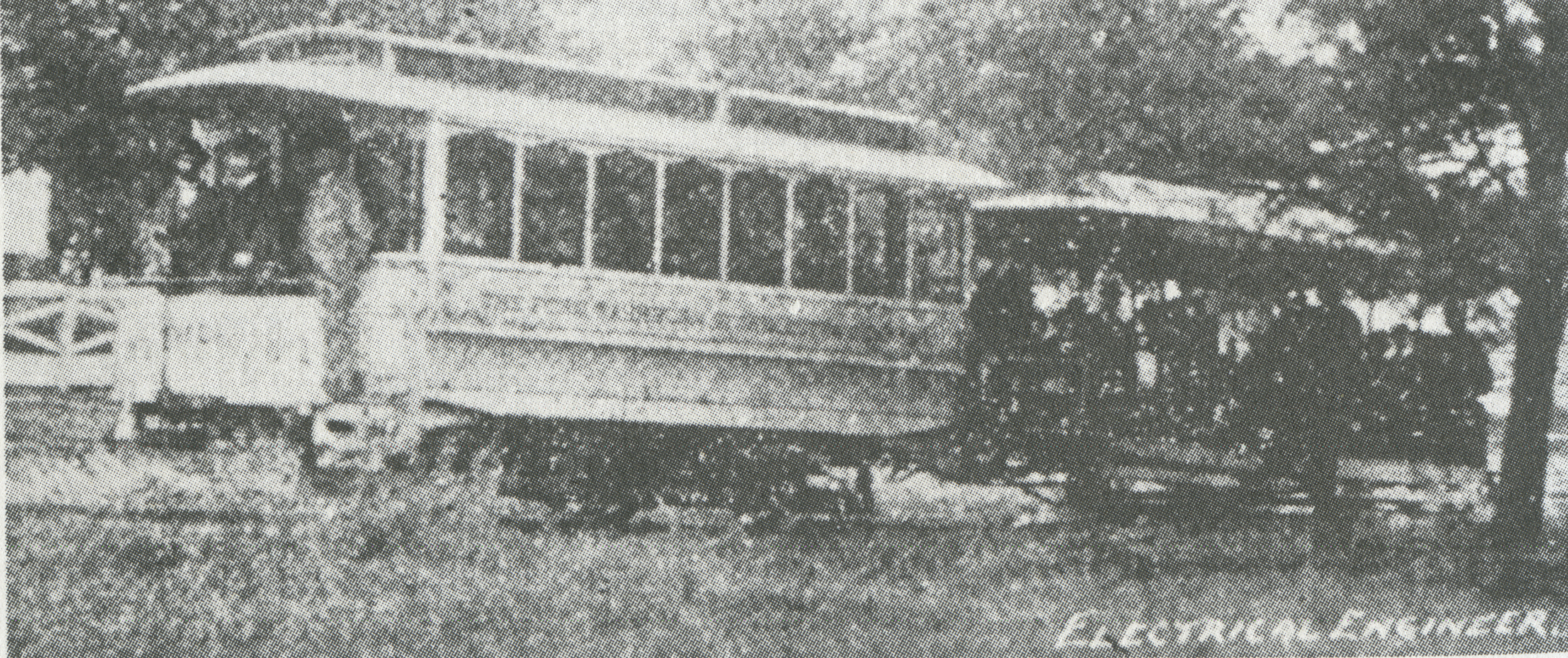 A Clevealnd and Berea Street Railway Battery Car tows a horsecar in 1893. both are filled with passengers. Text: Electrical Engineer