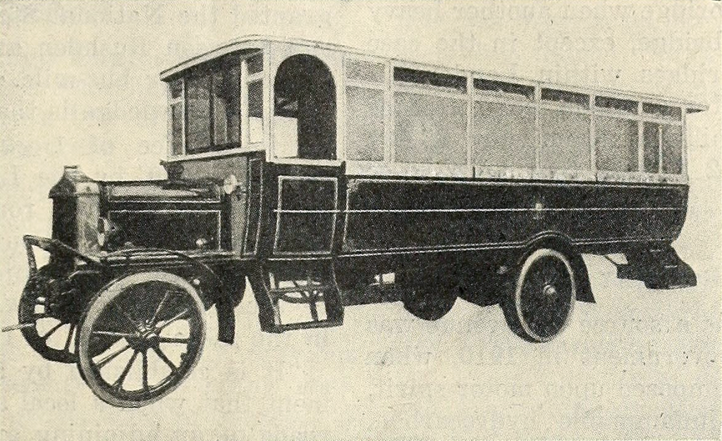 A black colored jitney bus circa 1920. Looks like most early automobiles, but lengthened significantly. Public Domain, Wikimedia Commons