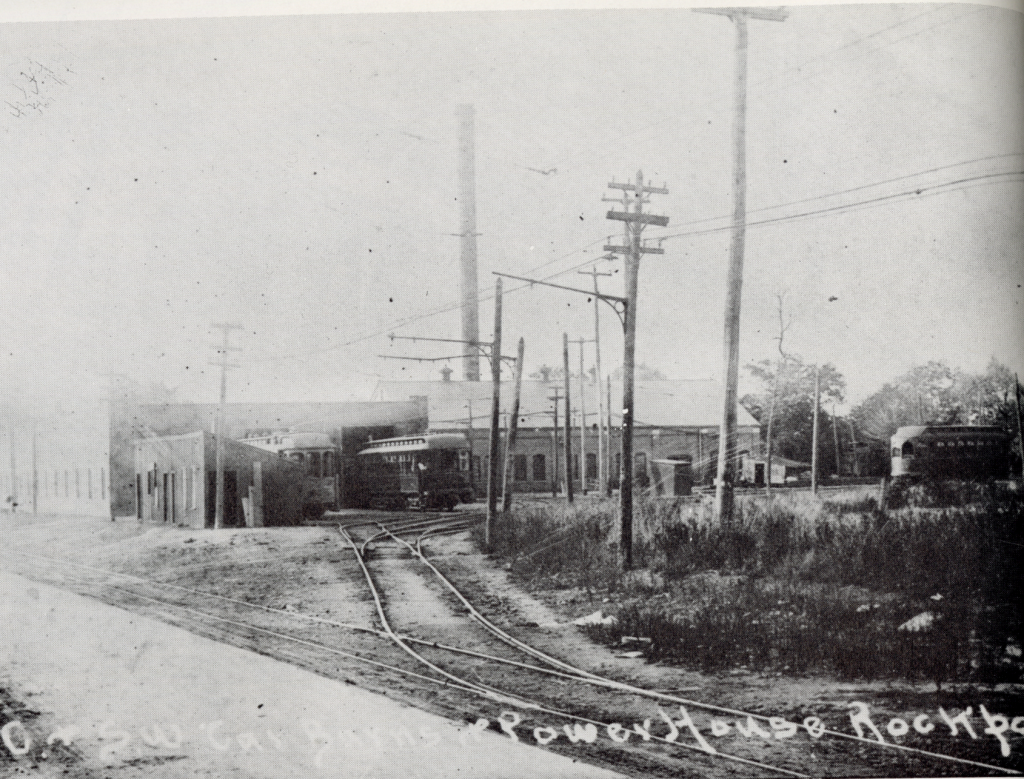 A Cleveland and Berea Street Railway Car towing a horsecar, both passing under a steam railroad bridge, circa 1890s. Text: Cleveland and Berea Railway